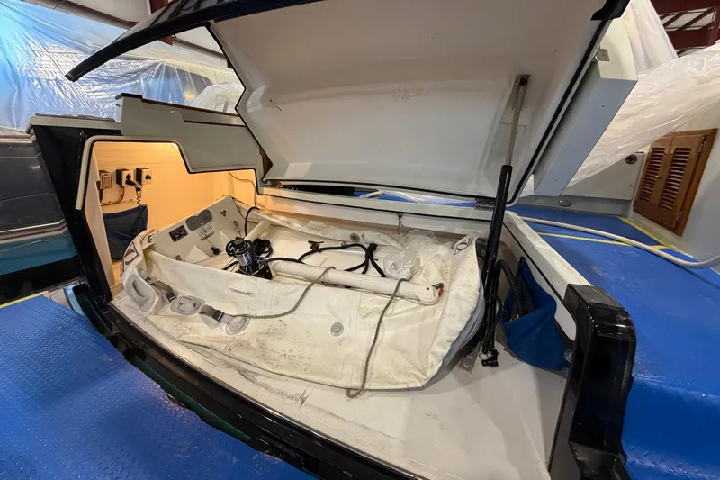 Slide: The Image of Open storage compartment of 2005 San Juan SJ 48 Flybridge yacht, showcasing interior equipment. - 89