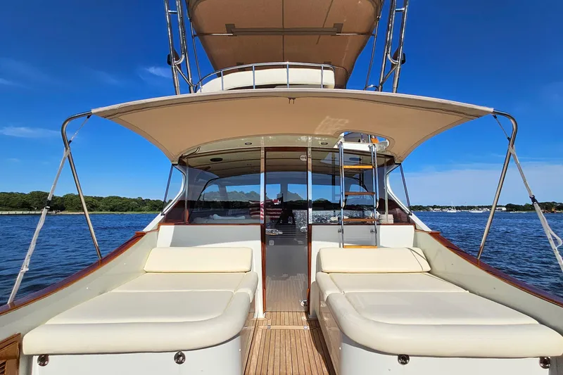 Slide: The Image of 2005 San Juan SJ 48 Flybridge yacht with spacious deck, cruising on a serene blue lake. - 34