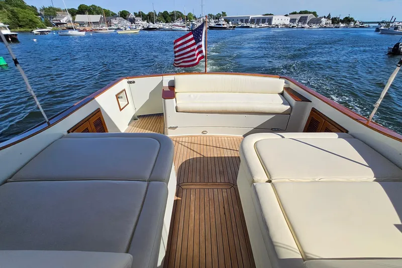 Slide: The Image of Luxurious 2005 San Juan SJ 48 Flybridge yacht with spacious deck and American flag. - 36