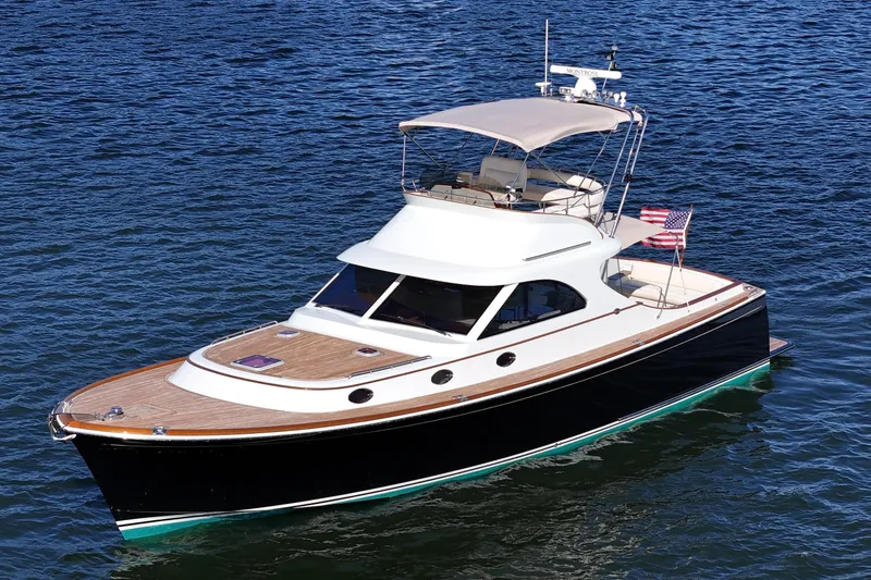 Slide: The Image of 2005 San Juan SJ 48 Flybridge yacht on calm blue water. - 18