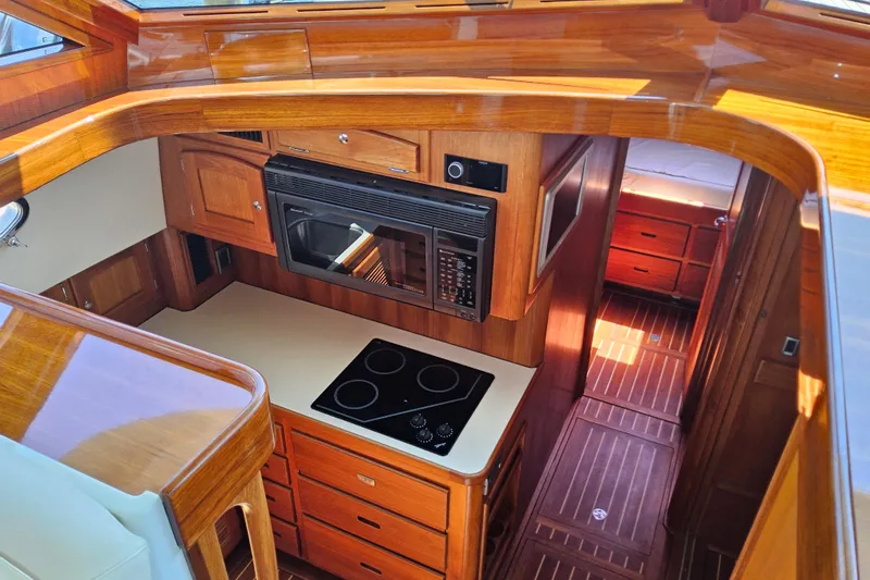 Slide: The Image of Luxurious 2005 San Juan 48 yacht interior with wooden cabinetry and modern kitchen amenities. - 59