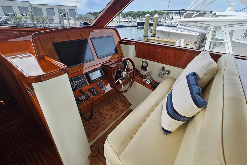 Slide: The Image of Luxurious 2005 San Juan 48 yacht helm with wooden dashboard and plush seating. - 50