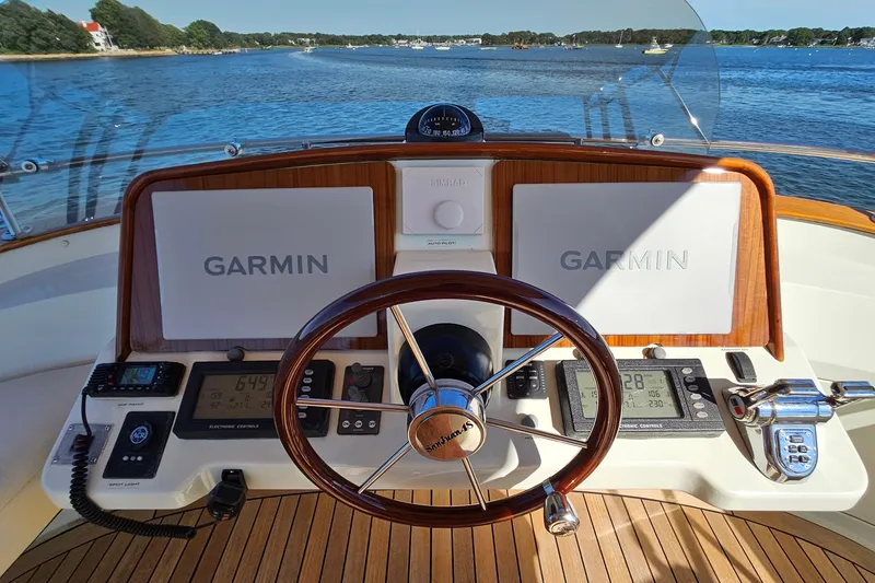 Slide: The Image of Helm of 2005 San Juan SJ 48 Flybridge with Garmin navigation, wooden wheel, and scenic water view. - 41