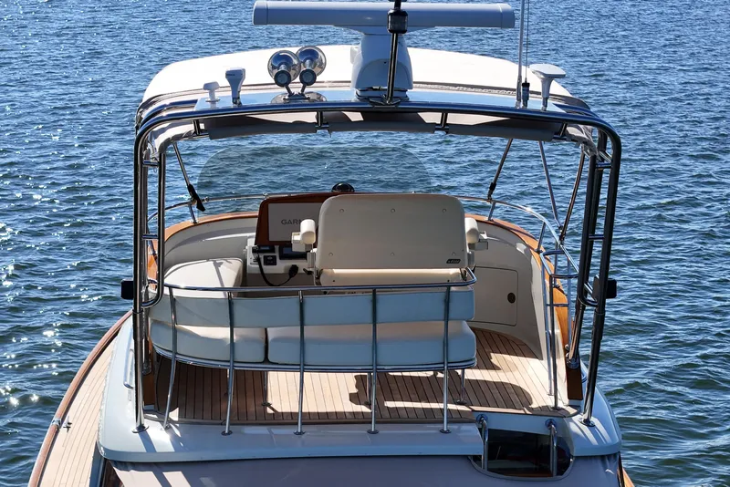 Slide: The Image of 2005 San Juan SJ 48 Flybridge yacht on water, showcasing elegant design and spacious deck. - 23