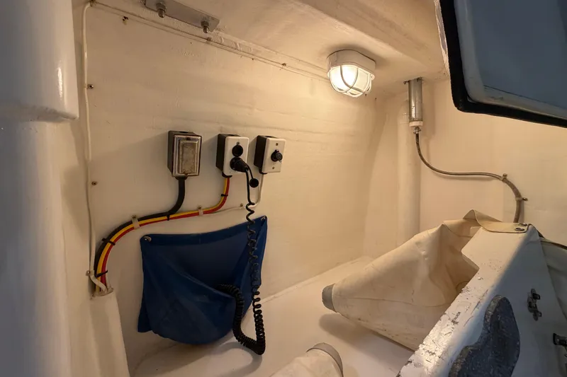 Slide: The Image of 2005 San Juan SJ 48 Flybridge interior with wiring, light, and storage compartment. - 90