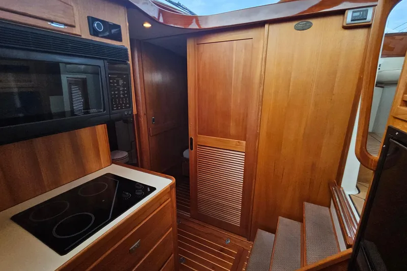 Slide: The Image of Interior of 2005 San Juan 48 yacht with wooden cabinetry and modern kitchen appliances. - 63