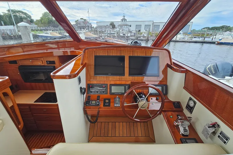 Slide: The Image of Luxurious 2005 San Juan 48 yacht helm with polished wood finish and modern navigation equipment. - 49