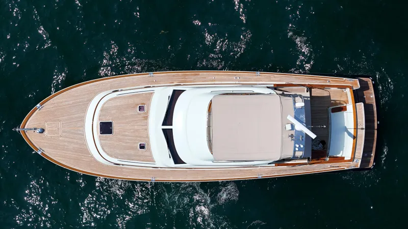 Slide: The Image of Aerial view of a 2005 San Juan SJ 48 Flybridge on the water. Sleek design with wooden deck. - 25