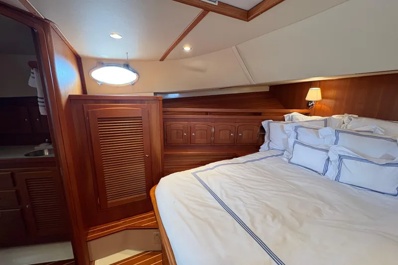 Slide: The Image of Luxurious cabin interior of 2005 San Juan SJ 48 Flybridge yacht with wood paneling. - 74
