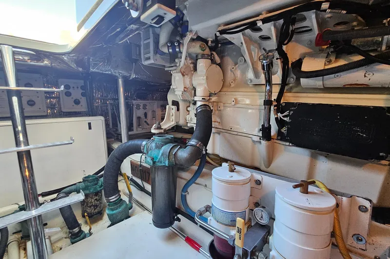 Slide: The Image of Engine room of a 2005 San Juan 48 yacht, showcasing mechanical components and piping. - 87