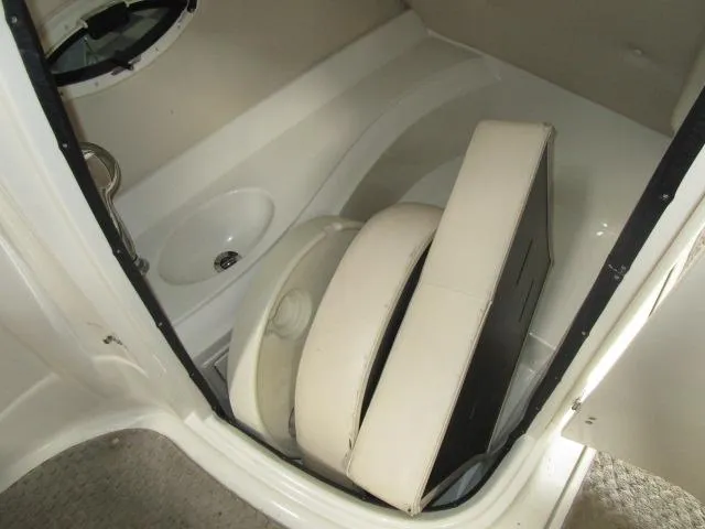 Slide: The Image of 2007 Azure AZ220 deckboat interior with white seating and storage compartment. - 11