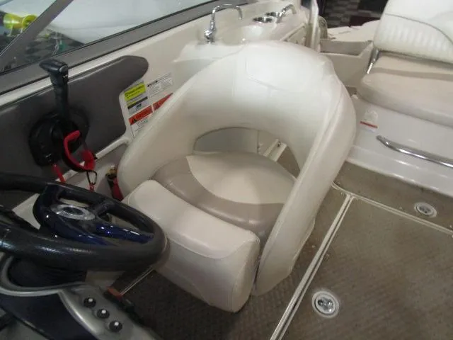 Slide: The Image of 2007 Azure AZ220 deckboat interior with steering wheel and cushioned seating. - 14
