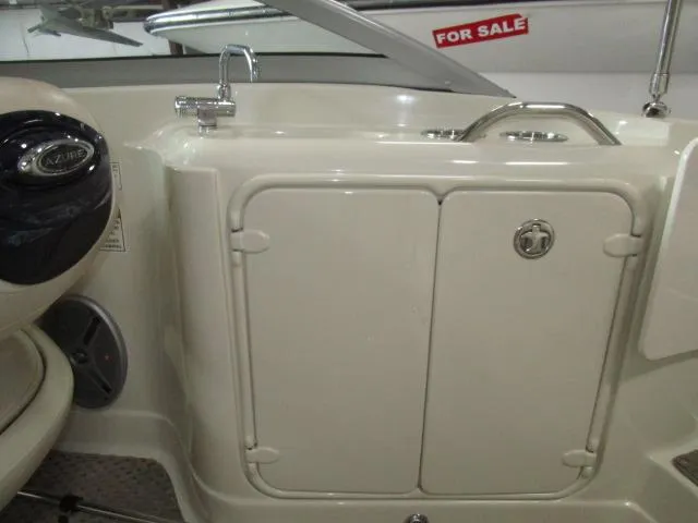 Slide: The Image of 2007 Azure AZ220 deckboat interior with sink and storage, for sale sign visible. - 17