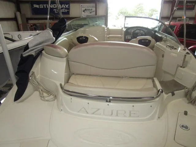Slide: The Image of 2007 Azure AZ220 deckboat interior with seating and steering wheel in a garage setting. - 18