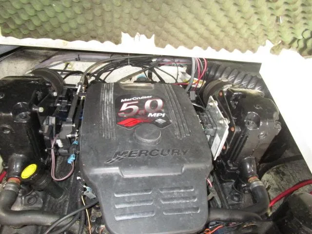 Slide: The Image of MerCruiser 5.0 MPI engine in 2007 Azure AZ220 deckboat, surrounded by wiring and insulation. - 19