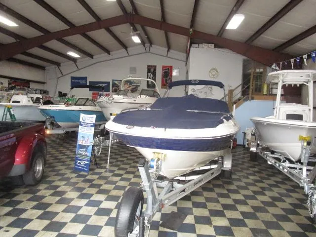 Slide: The Image of 2007 Azure AZ220 deckboat displayed in a showroom with checkered flooring. - 4