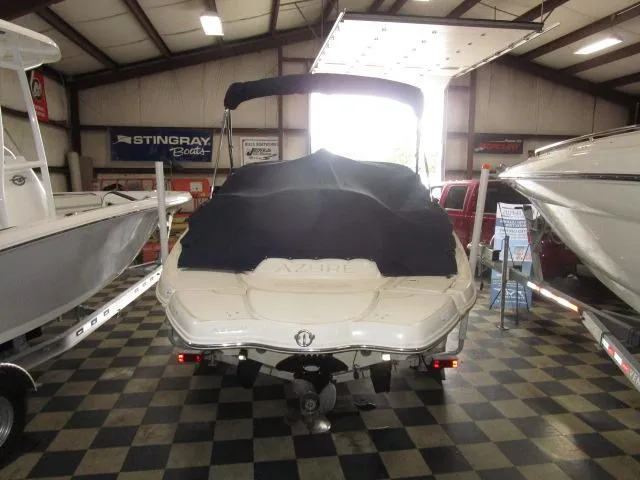 Slide: The Image of 2007 Azure AZ220 deckboat with cover in showroom, surrounded by other boats. - 5