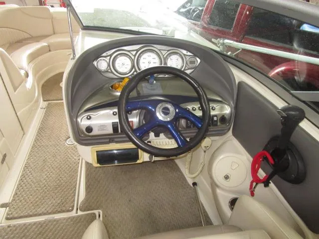 Slide: The Image of 2007 Azure AZ220 deckboat cockpit with steering wheel, gauges, and beige interior. - 8