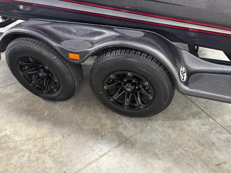 Slide: The Image of 2018 Bass Cat Eyra trailer with black wheels and sleek design on concrete floor. - 11