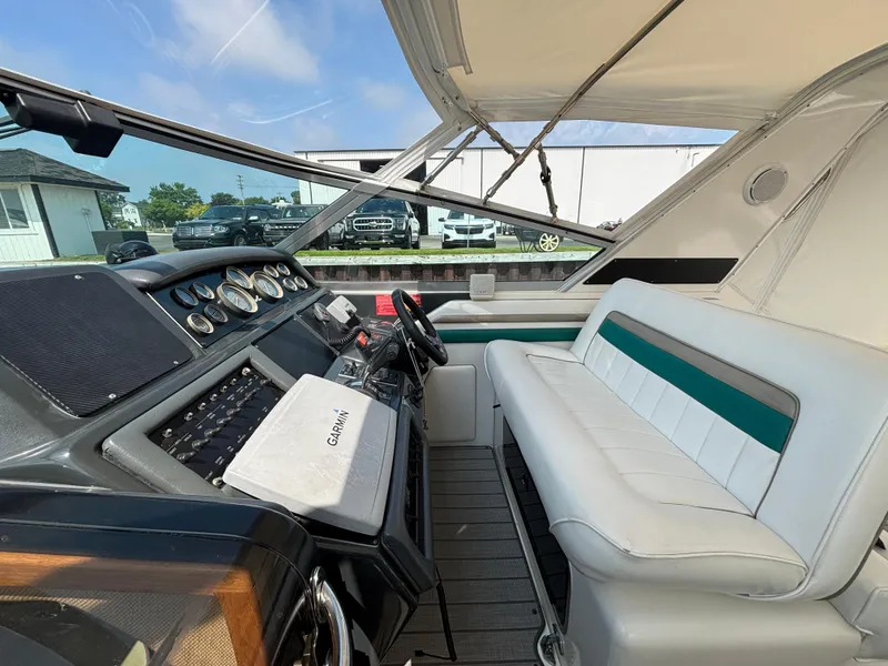 Slide: The Image of 1992 Sea Ray 400 EXPRESS cockpit with Garmin navigation, white seating, and control panel. - 10