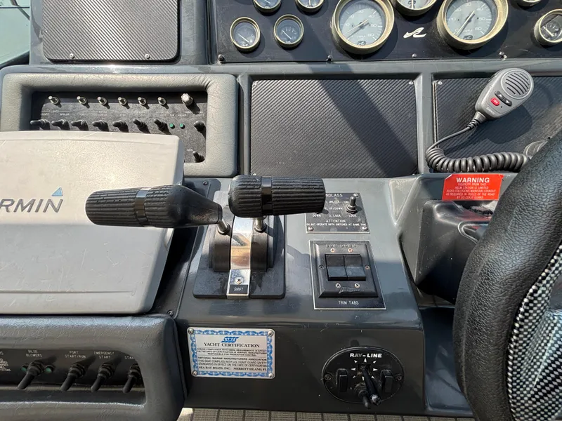 Slide: The Image of Control panel of a 1992 Sea Ray 400 EXPRESS boat with gauges and throttle levers. - 13