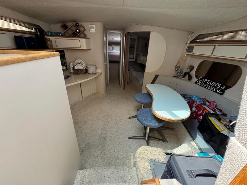 Slide: The Image of Interior of 1992 Sea Ray 400 EXPRESS yacht with dining area and cozy cabin. - 16