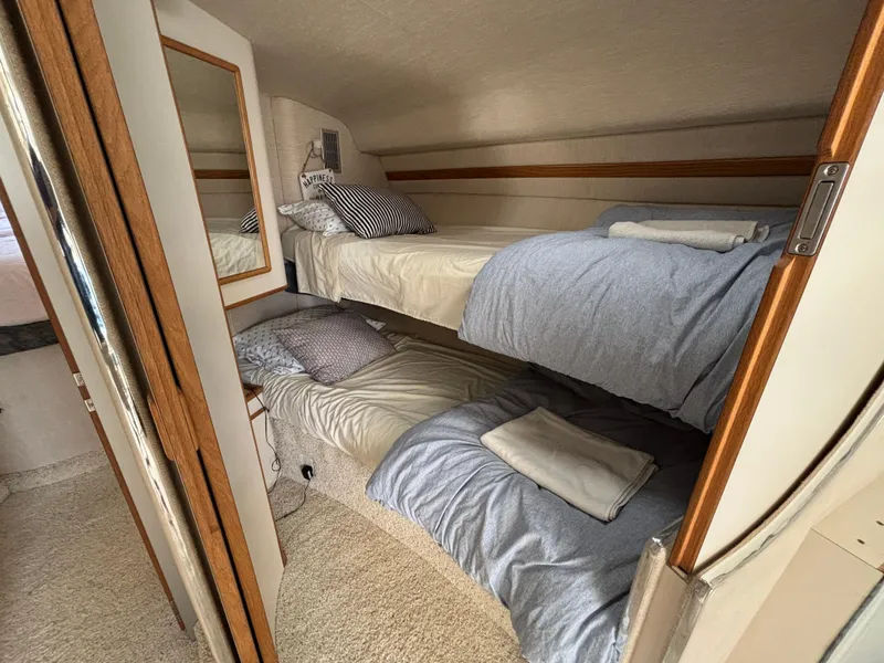 Slide: The Image of Interior of 1992 Sea Ray 400 EXPRESS with cozy bunk beds and wooden accents. - 19