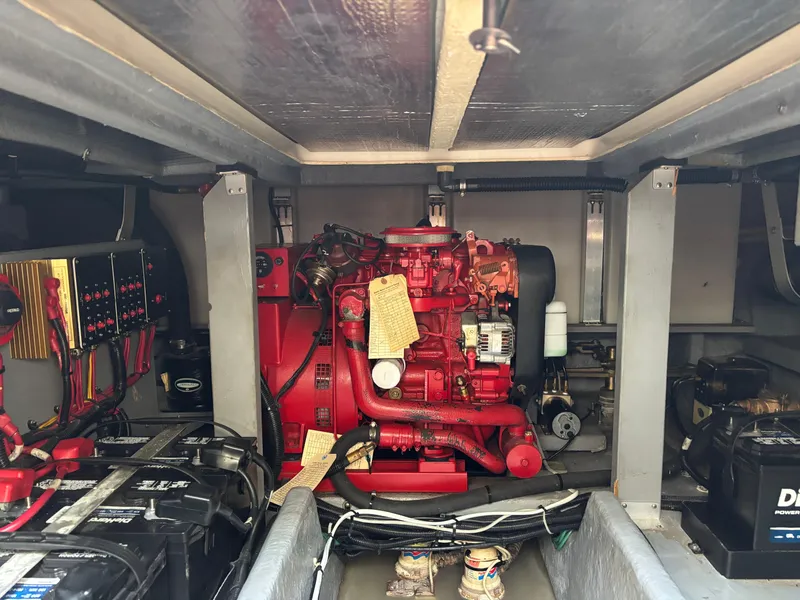 Slide: The Image of Engine room of a 1992 Sea Ray 400 EXPRESS with red engine and electrical components. - 24