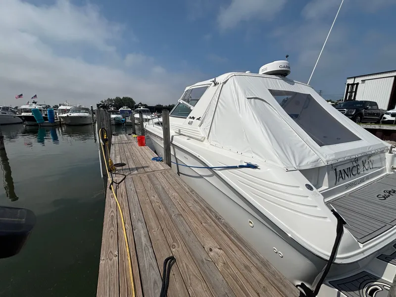 Slide: The Image of 1992 Sea Ray 400 EXPRESS docked at marina, clear sky, calm water. - 5