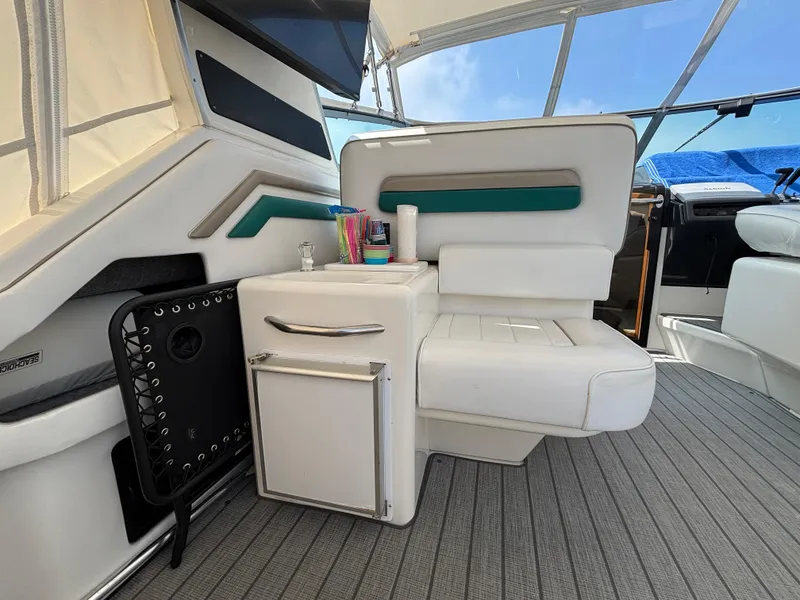 Slide: The Image of Interior of 1992 Sea Ray 400 EXPRESS yacht with white seating and storage cabinet. - 8
