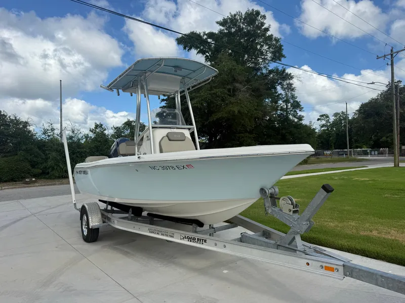 The Image of 2022 Key West 189FS boat on trailer, parked outdoors under a cloudy sky. - 1