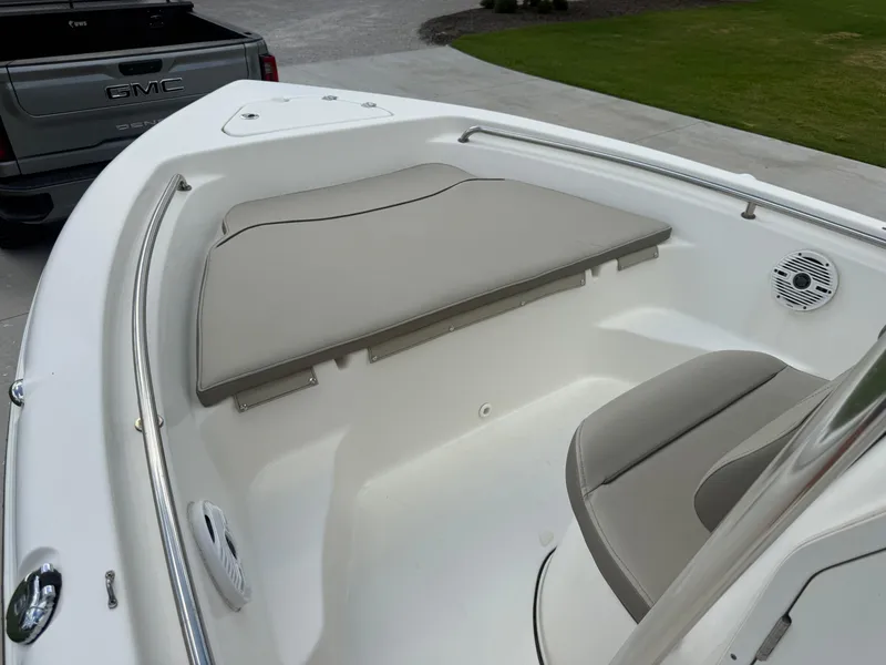 Slide: The Image of 2022 Key West 189FS boat interior with cushioned seating and stainless steel railing. - 14