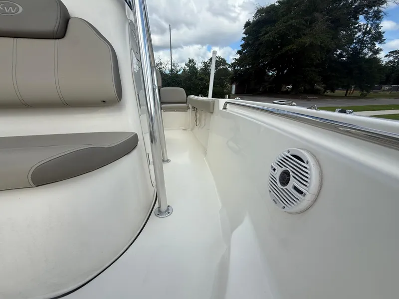 Slide: The Image of 2022 Key West 189FS boat interior with seating and speaker, under cloudy sky. - 15