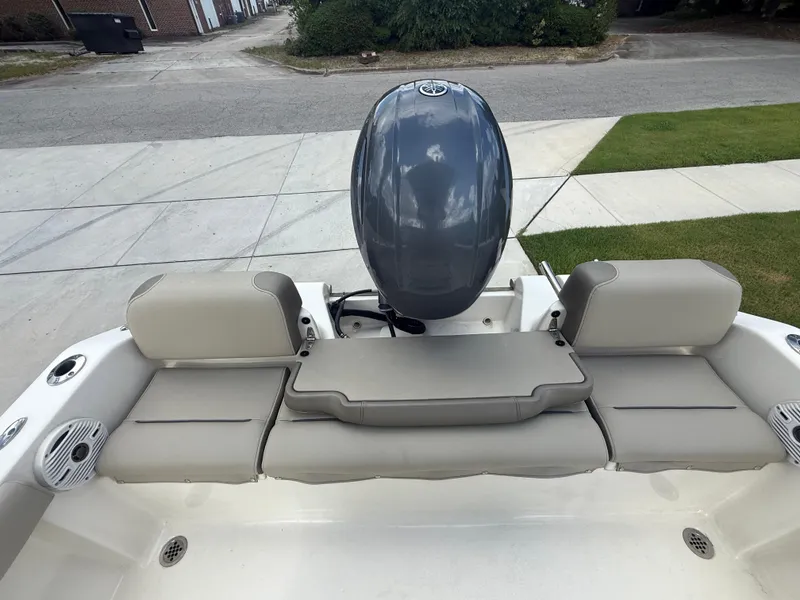 Slide: The Image of 2022 Key West 189FS boat with gray seating and outboard motor, parked on a driveway. - 18