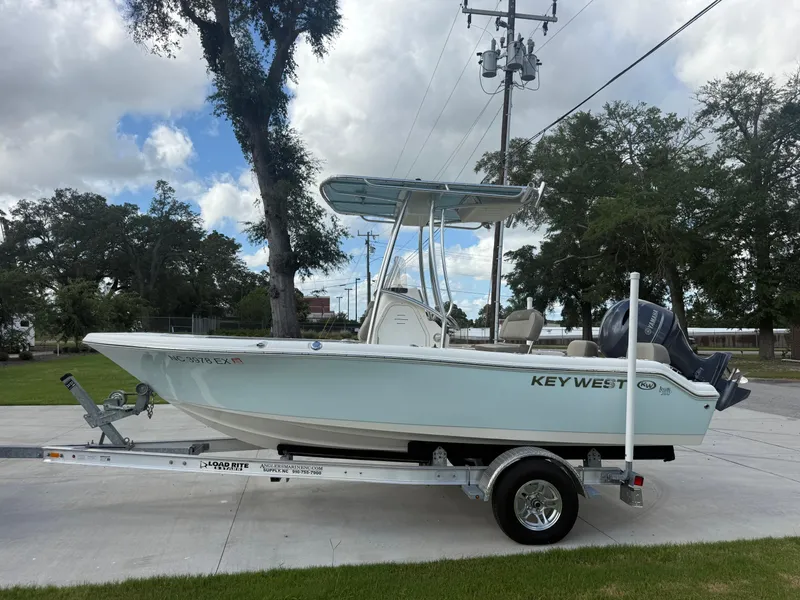 Slide: The Image of 2022 Key West 189FS boat on trailer, parked outdoors under cloudy sky. - 3