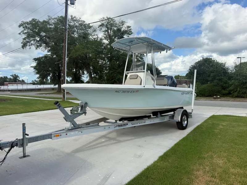 Slide: The Image of 2022 Key West 189FS boat on trailer, parked outdoors under cloudy sky. - 4