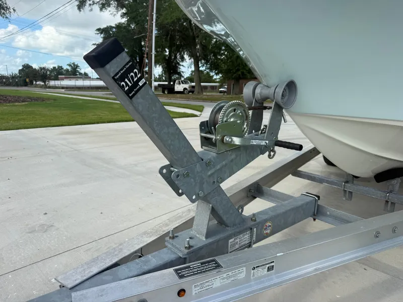 Slide: The Image of 2022 Key West 189FS boat on trailer with winch system, parked on concrete driveway. - 8