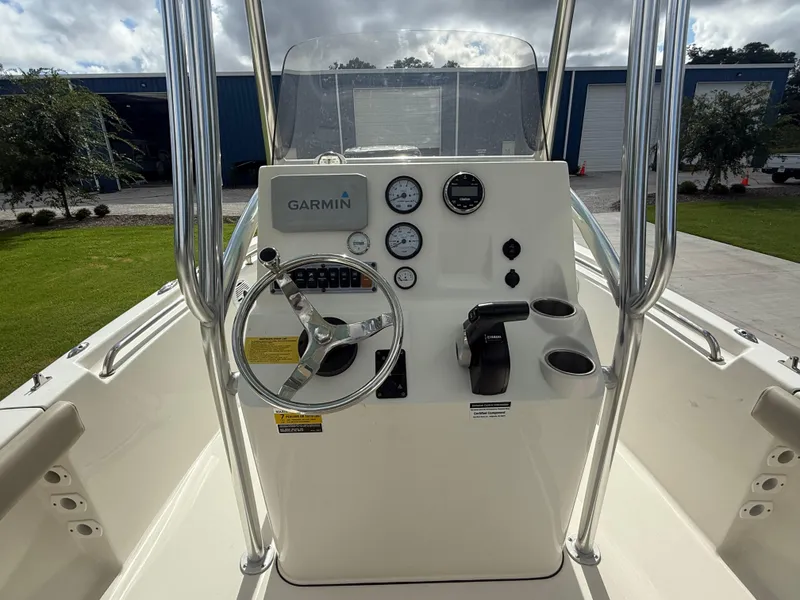 Slide: The Image of 2022 Key West 189FS boat console with Garmin navigation, steering wheel, and gauges. - 9