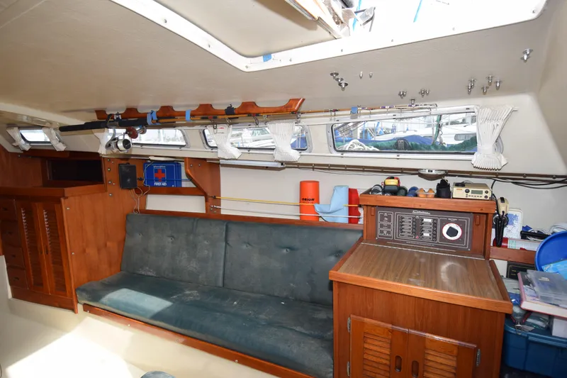 Slide: The Image of Interior of a 1984 Catalina 30 sailboat with wooden cabinetry and seating area. - 1