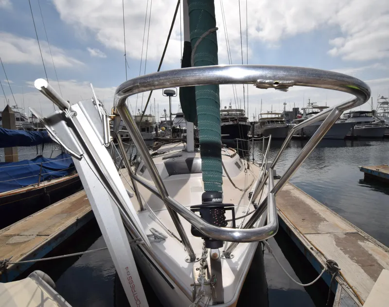 Slide: The Image of 1984 Catalina 30 sailboat docked at marina, featuring bow and anchor. - 12