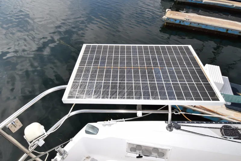 Slide: The Image of Solar panel on 1984 Catalina 30 sailboat, docked on calm water. - 13