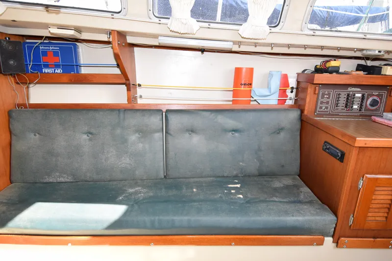 Slide: The Image of Interior of 1984 Catalina 30 sailboat with green cushions and navigation panel. - 4