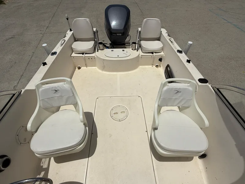 Slide: The Image of 2004 Sea Hunt Escape 175 boat interior with seating and outboard motor. - 10