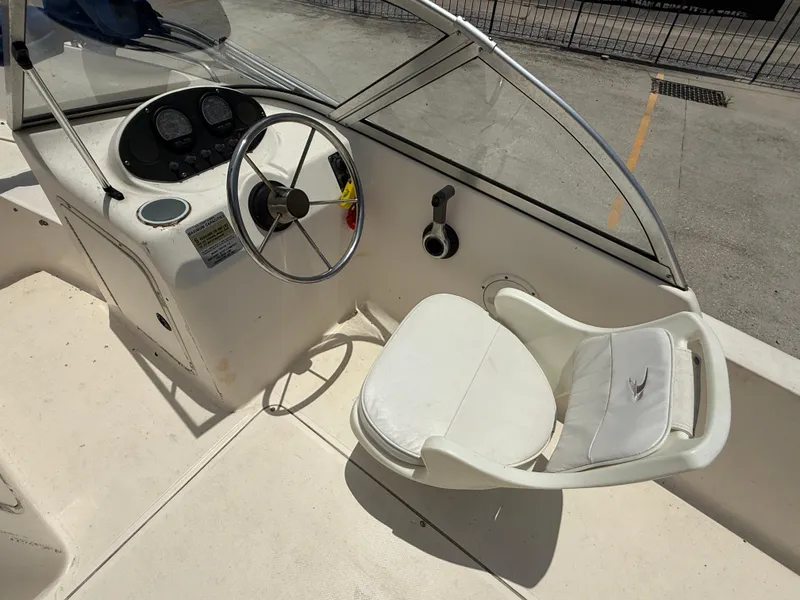 Slide: The Image of 2004 Sea Hunt Escape 175 boat interior with steering wheel and seat. - 11