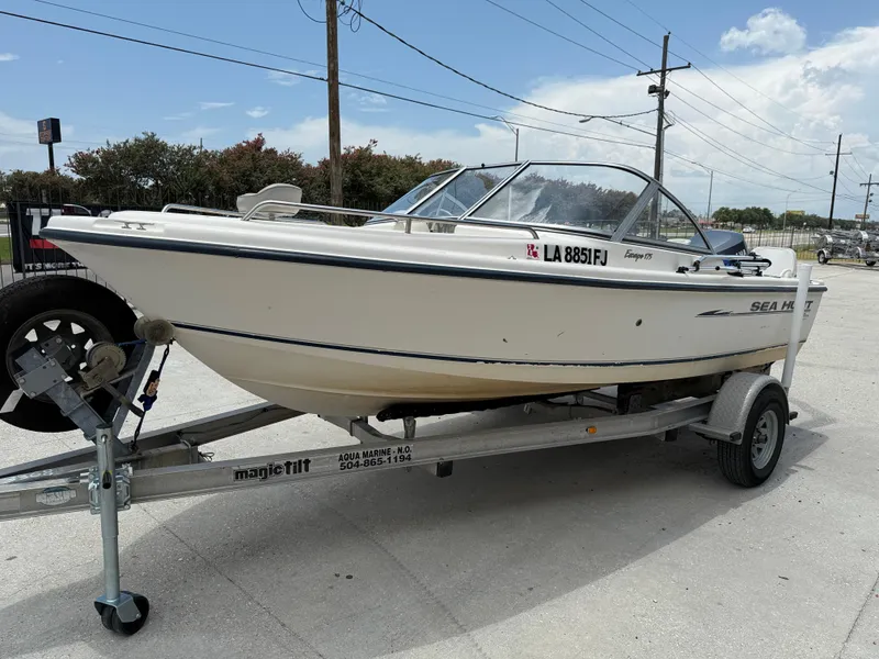 Slide: The Image of 2004 Sea Hunt Escape 175 boat on trailer, parked outdoors under clear sky. - 4