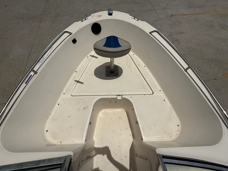 Slide: The Image of 2004 Sea Hunt Escape 175 boat interior with seating and storage compartments. - 9