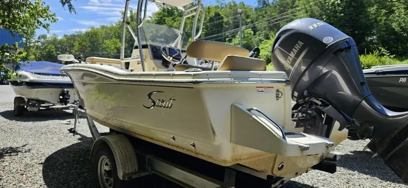 Slide: The Image of 2016 Scout 195 Sportfish boat on trailer with Yamaha outboard motor, parked outdoors. - 5