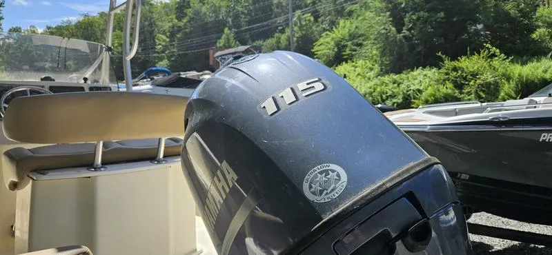 Slide: The Image of 2016 Scout 195 Sportfish boat with Yamaha 115 outboard motor in a sunny outdoor setting. - 6