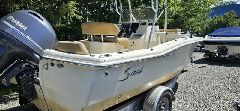 Slide: The Image of 2016 Scout 195 Sportfish boat with Yamaha engine on trailer, parked outdoors. - 7