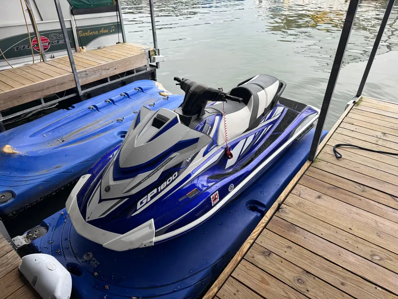 Slide: The Image of 2018 Yamaha WaveRunner GP1800R SVHO jet ski docked on a wooden pier. - 1